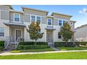 Beautiful townhome featuring a modern exterior and a meticulously landscaped front yard at 15946 Marina Bay Dr, Winter Garden, FL 34787