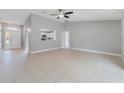 Bright and airy living room with neutral paint, tile flooring and an open layout to the kitchen at 160 Conch Dr, Kissimmee, FL 34759