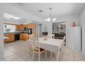 Open-concept kitchen and dining area with updated appliances and tiled floor at 217 Spencer St, Orlando, FL 32839