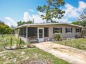 Lovely single-story home featuring a screened in porch, a charming front yard and a cozy curb appeal at 221 Golden Days Dr, Casselberry, FL 32707