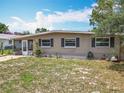 Single-story home with front lawn and a white picket fence, exuding a cozy, neighborhood charm at 221 Golden Days Dr, Casselberry, FL 32707