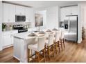Bright, open kitchen featuring white cabinets, stainless steel appliances, and a large center island with bar seating at 2502 Linda Knoll Ln, Bartow, FL 33830