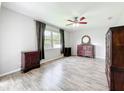 Comfortable bedroom with wood-look flooring, a ceiling fan, and lots of natural light at 2528 Double Tree Pl, Oviedo, FL 32766
