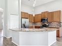 Spacious kitchen with granite countertops, stainless steel appliances, mosaic backsplash and wood cabinets at 2528 Double Tree Pl, Oviedo, FL 32766