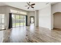 Spacious living room with hardwood floors, ceiling fan, and sliding glass doors to backyard at 2528 Double Tree Pl, Oviedo, FL 32766