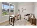 Bright home office featuring a large window, desk, comfortable chair, and stylish decor at 3022 Peel Ave, Orlando, FL 32806