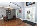 Formal dining room featuring hardwood floors, crown molding, and stylish decor at 319 Morning View Dr, Winter Garden, FL 34787