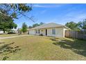 View of house exterior with siding, green lawn, and driveway with room for parking at 3342 Sanborn Ln, Deltona, FL 32738
