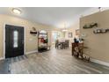 Inviting foyer with wood-look tile flooring, leading to the dining area at 3342 Sanborn Ln, Deltona, FL 32738