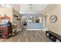 Open-concept living room featuring wood-look tile flooring and stylish decor and arched doorways at 3342 Sanborn Ln, Deltona, FL 32738