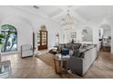 Bright, airy living room featuring tile floors, arched doorways, and a comfortable seating area at 4031 Bermuda Grove Pl, Longwood, FL 32779