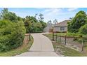 Long driveway leading to a well-maintained home and detached garage, surrounded by lush landscaping at 41128 Apple St, Eustis, FL 32736