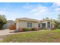 Well-maintained home with a detached garage, lush landscaping, and inviting curb appeal at 41128 Apple St, Eustis, FL 32736