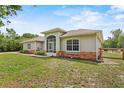 Charming single-story home with a screened entrance and mixed material facade at 41128 Apple St, Eustis, FL 32736