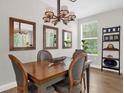 Cozy dining room with stylish lighting and a wooden table at 4284 New Broad St # 102, Orlando, FL 32814