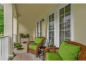 Inviting outdoor sitting area on the porch with comfortable chairs and natural light at 4284 New Broad St # 102, Orlando, FL 32814