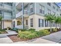 Charming building exterior with balconies overlooking landscaped grounds and sidewalks at 611 Campus St # 160, Celebration, FL 34747