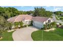 Home boasts a spacious driveway leading to a three-car garage, complemented by well-manicured landscaping at 6121 Oxbow Bend Ln, Port Orange, FL 32128