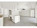 Open concept living room and kitchen area with modern ceiling fan and fixtures at 9241 Eagles Perch Pl, Orlando, FL 32825