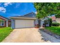 Single story house with a blue exterior, manicured landscaping, and a spacious two-car garage at 3010 Egrets Landing Dr, Lake Mary, FL 32746