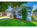 Beautiful one-story home with a blue exterior, manicured landscaping, and a two-car garage at 3010 Egrets Landing Dr, Lake Mary, FL 32746