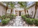 Inviting entrance with mature landscaping and a well-maintained walkway leading to the front door at 1062 Wickerwood St, Ocoee, FL 34761