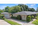 View of a well-maintained house with a detached garage, offering ample parking at 1271 Old Mill Rd, Orlando, FL 32806