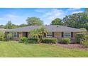 Charming brick home featuring a well-manicured lawn and mature landscaping at 1271 Old Mill Rd, Orlando, FL 32806