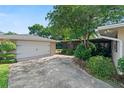 Detached two-car garage with long driveway and mature landscaping at 1271 Old Mill Rd, Orlando, FL 32806