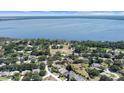 Expansive aerial view showcases the serene lakefront community surrounded by lush greenery at 13631 Via Roma Cir, Clermont, FL 34711
