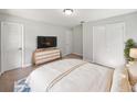 Cozy bedroom with neutral colors, soft carpet, and a dresser with a TV on top at 13794 Sw 112Th St, Dunnellon, FL 34432