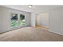 Bright living room features neutral carpet and fresh paint, perfect for relaxation at 13794 Sw 112Th St, Dunnellon, FL 34432