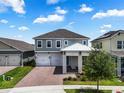 Beautiful two-story home featuring a cozy front porch, a two-car garage, and nicely manicured landscaping at 14955 Lebeau Loop, Winter Garden, FL 34787