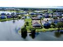 Wide shot of the community, showing the lake view, surrounding homes and beautiful Florida landscape at 15510 Lake Burnett Shore Ct, Winter Garden, FL 34787