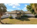 Well-maintained single-story home featuring stone accents, a new roof, manicured lawn, and mature palm trees at 16190 Sw 16Th Ct, Ocala, FL 34473