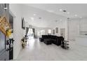 Bright, open living room with modern furnishings, recessed lighting, and tile flooring with views of the pool at 16190 Sw 16Th Ct, Ocala, FL 34473