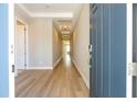 Long hallway with tray ceiling and recessed lights as viewed from front door at 16489 Silver Brook Way, Winter Garden, FL 34787