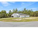 Contemporary home with a white exterior, set against a backdrop of lush trees at 17762 Sw 33Rd Ter, Ocala, FL 34473