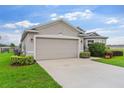 Charming single-story home featuring manicured lawn, two car garage, and a side yard at 1805 Kingsmill Dr, Bartow, FL 33830