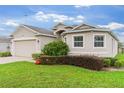 Charming single-story home featuring manicured lawn, two car garage, and lush landscaping at 1805 Kingsmill Dr, Bartow, FL 33830