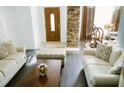 Inviting living room with hardwood floors, stone pillar accent and comfortable seating at 2102 Applegate Dr, Ocoee, FL 34761