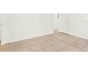Neutral bedroom featuring tile flooring, white walls, and natural light at 2417 Cedar Ave, Sanford, FL 32771