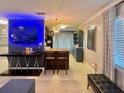 Open-concept living room featuring a dining area, modern lighting, and neutral tile flooring at 3130 S Bumby Ave # S, Orlando, FL 32806