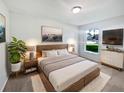 Well-lit bedroom with a modern bed frame and coordinated decor, creating a cozy atmosphere at 612 Doe Cove Pl, Apopka, FL 32703