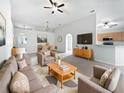 Bright and airy living room featuring an open floor plan with a view of the dining area at 612 Doe Cove Pl, Apopka, FL 32703