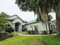 Charming single-Gathering home with mature landscaping, green lawn, and moss-draped trees at 635 Whitman Cv, Longwood, FL 32750