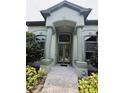 Inviting front entrance featuring double doors, large windows, and manicured landscaping at 635 Whitman Cv, Longwood, FL 32750