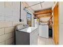 Laundry room features washer, dryer, water heater, and wood shelving at 7024 Harwick Dr, Orlando, FL 32818