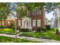 Charming two-story brick home with a well-manicured lawn and lovely green door at 704 Honeysuckle Ave, Kissimmee, FL 34747