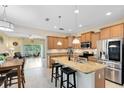 Bright kitchen featuring stainless steel appliances, granite countertops, a kitchen island, and pendant lighting at 707 Evening Sky Dr, Oviedo, FL 32765
